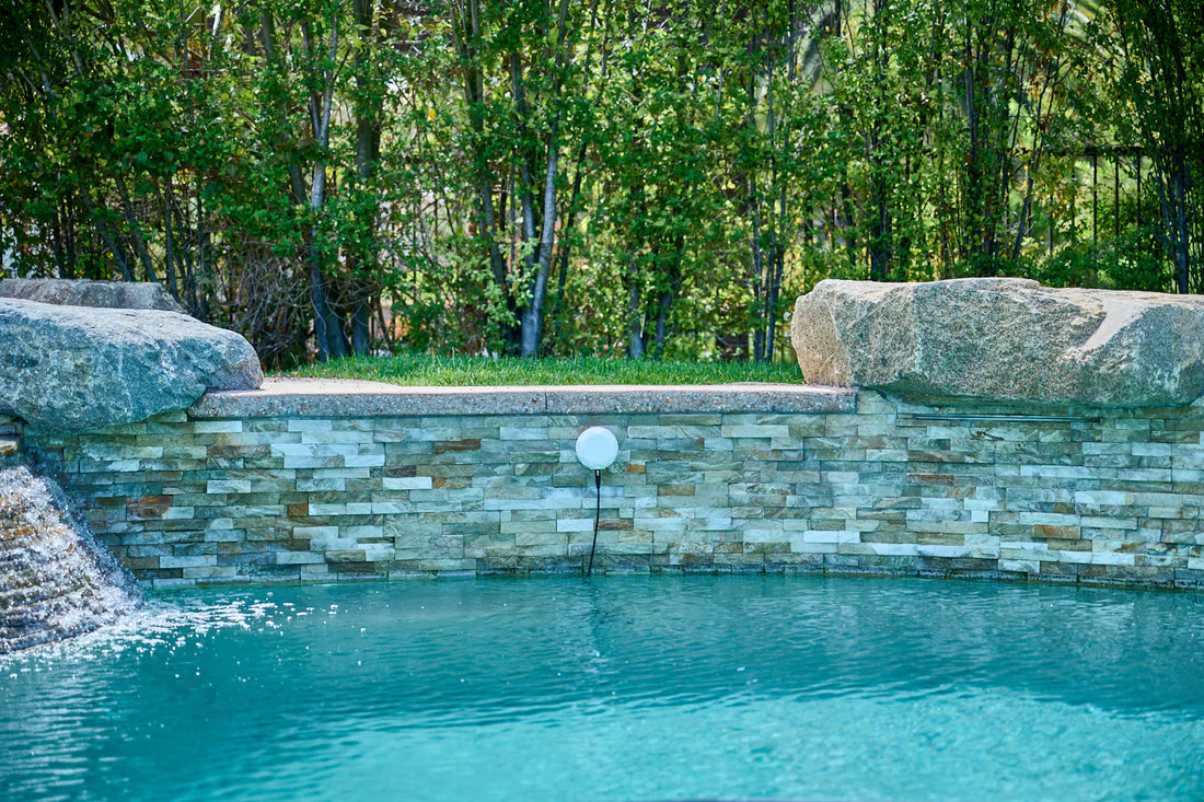 A serene backyard pool scene with a modern pool monitoring device floating on clear water, surrounded by greenery and a lounging area.